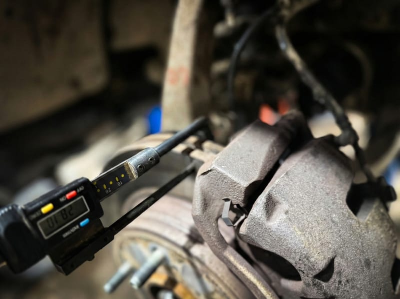 Digital brake pad measurement gauge showing precise pad thickness