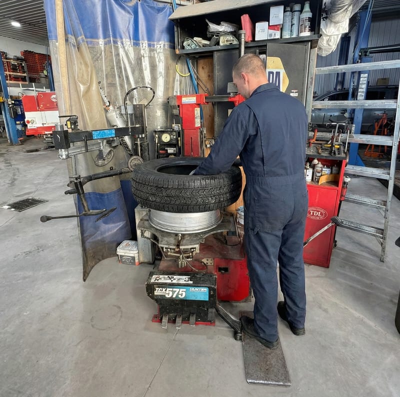 Technician mounting tire on Hunter tire changer